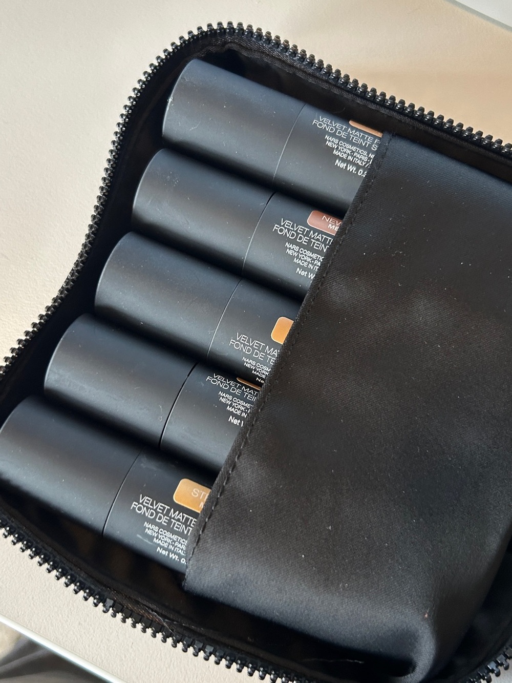 NARS 10 shade Velvet Matte Foundation Stick Set in Black Nylon Zip Cosmetic Bag.